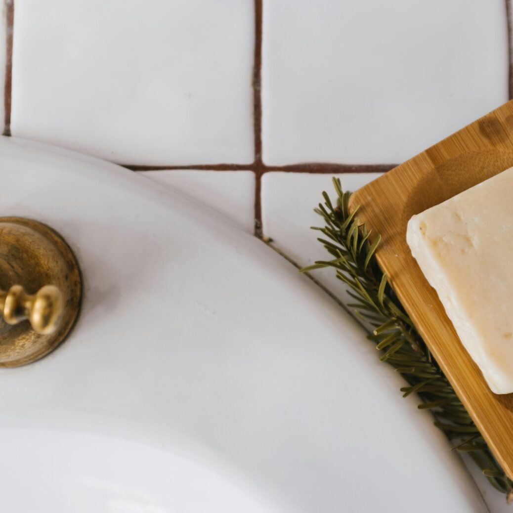 gold round ornament on white ceramic sink