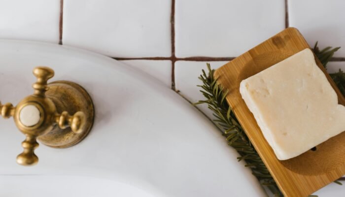 gold round ornament on white ceramic sink