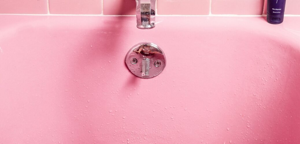 white bathtub filled with water